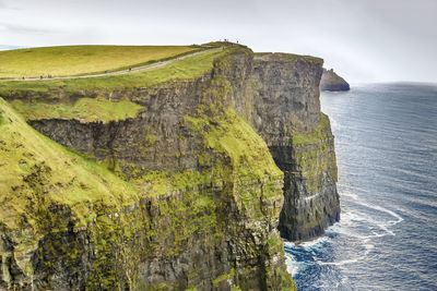 Scenic view of rock formation in sea against sky