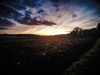 Scenic view of field against sky during sunset