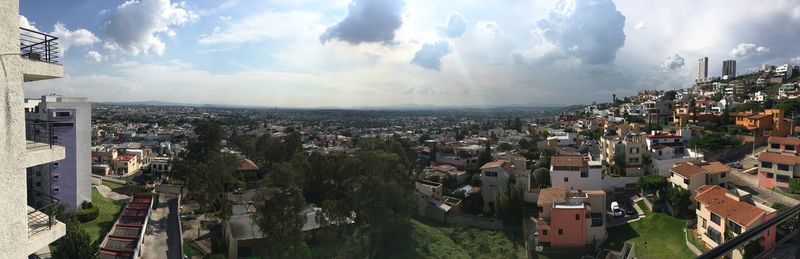 High angle view of town against cloudy sky