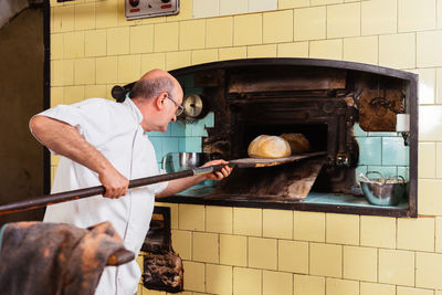 Side view of man working in workshop