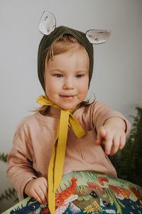 Toddler baby girl in funny hat with ears having fun