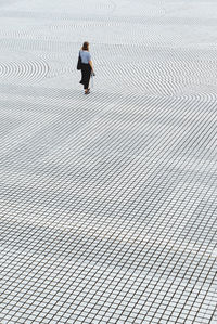 High angle view of woman standing on footpath