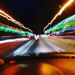 Light trails on road seen through car windshield