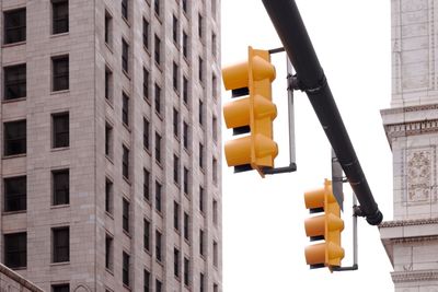 Low angle view of yellow buildings against sky in city