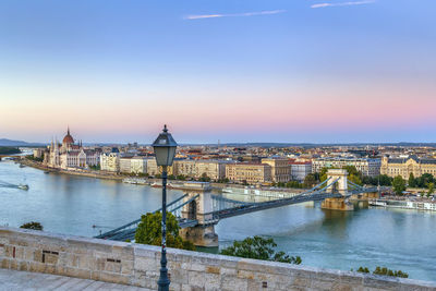 View of budapest with szechenyi chain bridge from fisherman bastion at sunset, hungary