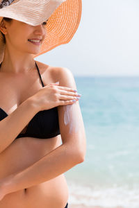 Midsection of woman at beach