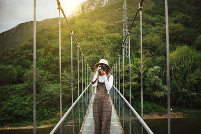 Woman standing on footbridge