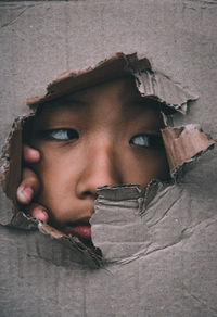Close-up portrait of a serious young man looking away