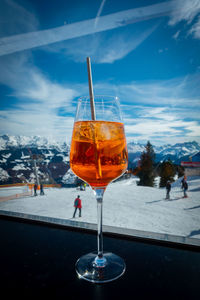 Close-up of beer in glass against sky