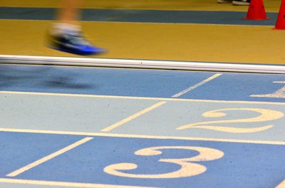 Low section of person running on road