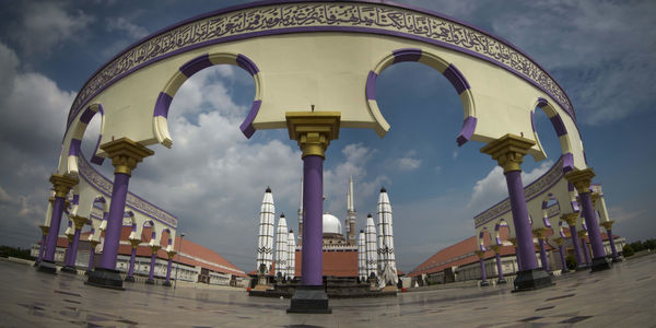 Low angle view of bridge against cloudy sky