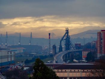 View of factory against cloudy sky