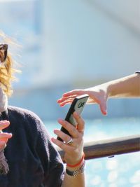 Close-up of woman hand holding mobile phone