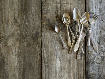 Directly above shot of abandoned silverware on old table