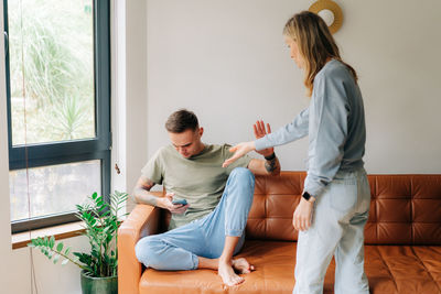 A woman quarrels with her husband about using a mobile phone and ignoring problems.