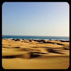 Scenic view of beach against clear sky