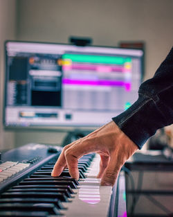 Close-up of man playing piano