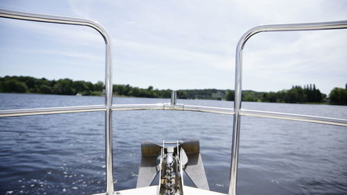 Railing by sea against sky