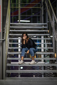 Young woman sitting on staircase