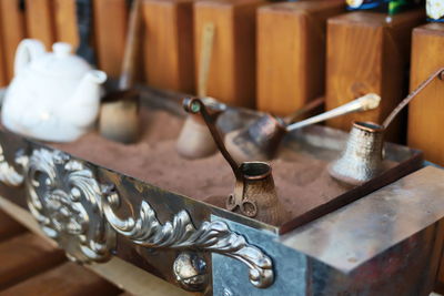 Close-up of metal containers on table