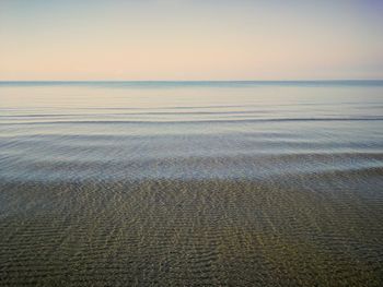 Scenic view of sea against clear sky during sunset