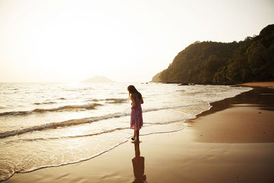 Girl on beach, sunset.