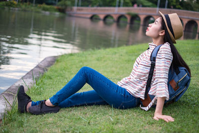 Side view of senior woman sitting on grass