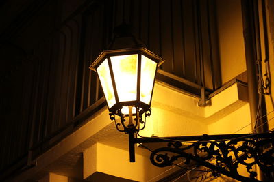 Low angle view of illuminated lamp at night