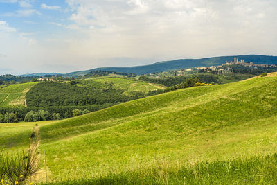 Scenic view of green landscape against sky