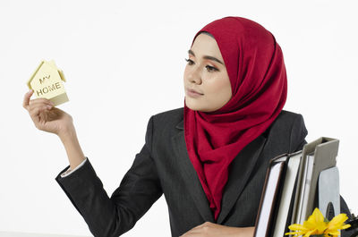 Portrait of beautiful young woman with text against white background