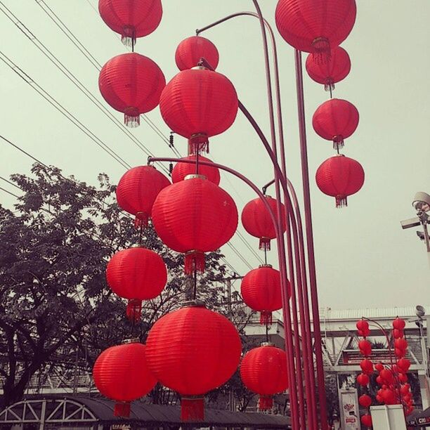 red, low angle view, hanging, decoration, lantern, in a row, lighting equipment, built structure, cultures, clear sky, architecture, tradition, chinese lantern, no people, day, outdoors, celebration, culture, cable, sky