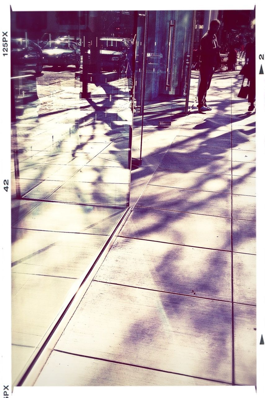 transfer print, auto post production filter, low section, walking, lifestyles, men, person, street, sidewalk, tiled floor, standing, leisure activity, shadow, full length, reflection, sunlight, paving stone