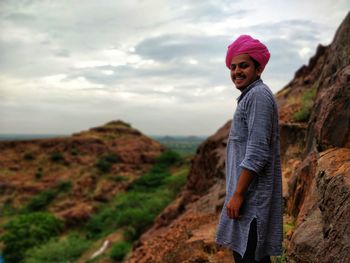 Full length of woman standing on land against sky