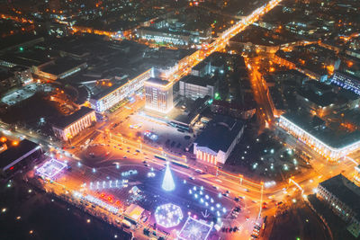 High angle view of illuminated city street and buildings at night