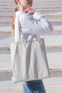 Portrait of cute girl standing against wall