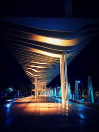 Illuminated underground walkway at night