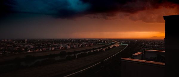 High angle view of illuminated buildings against sky during sunset