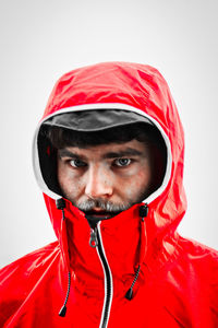 Portrait of smiling young man against white background