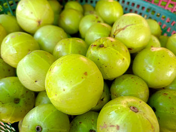 An indian gooseberry in the basket on a wooden floor