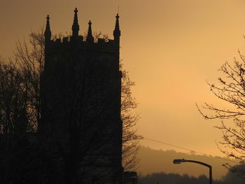 Silhouette of clock tower at sunset