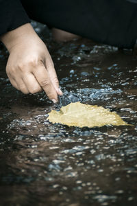 Close-up of person preparing food on table