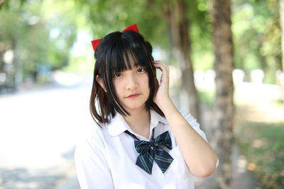 Portrait of young woman standing outdoors