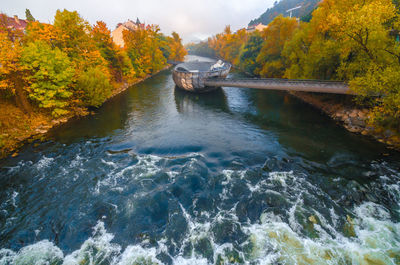 Mur river in autumn, with murinsel bridge in the city center of graz styria region austria