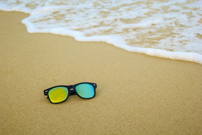 High angle view of sunglasses on beach