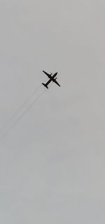 Low angle view of airplane against clear sky