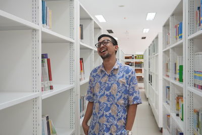 Smiling man standing at library