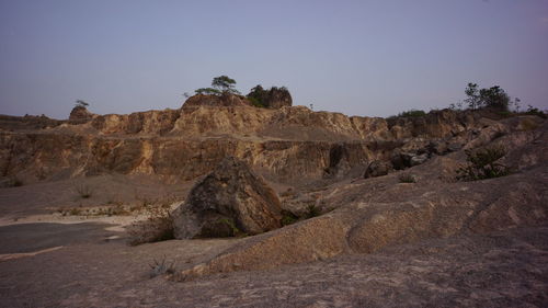 Rock formations on landscape against clear sky