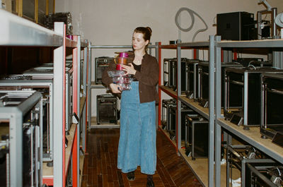 Side view of young woman standing in office