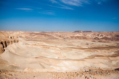 Scenic view of desert against blue sky