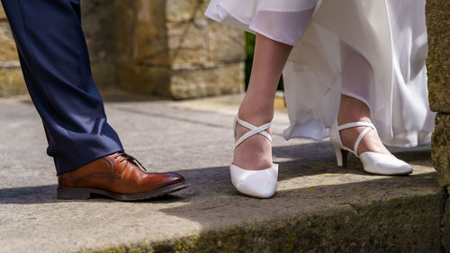 Low section of couple standing outdoors